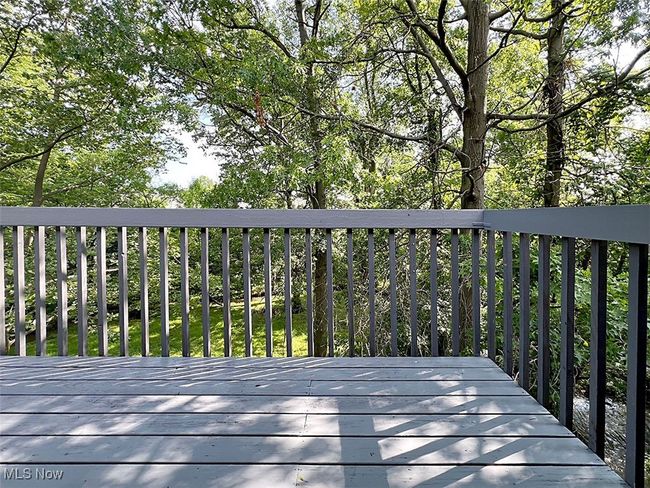 Balcony with view of back wooded property | Image 24
