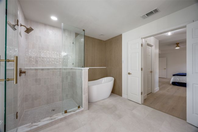 Bathroom with a tile shower, a freestanding bath, ensuite bath, and ceiling fan | Image 21