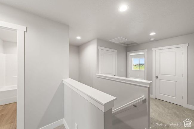 Hallway featuring an upstairs landing, baseboards, recessed lighting, and light colored carpet | Image 12