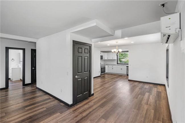 living room featuring a chandelier, dark wood-type flooring, baseboards, and recessed lighting | Image 15