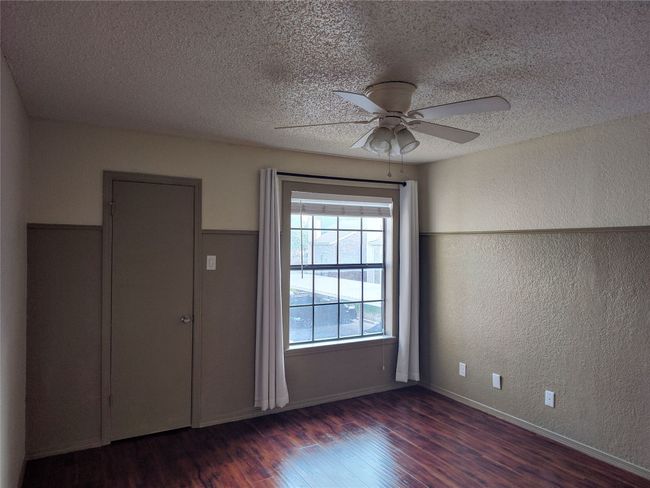 Empty room featuring dark hardwood / wood-style flooring, ceiling fan | Image 10