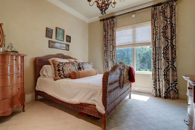 Fourth bedroom has chandelier, bathroom, custom drapes, crown molding, venetian plaster and walk in closet. | Image 35