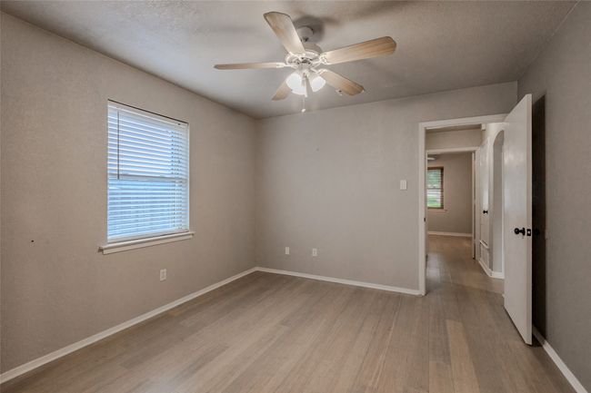 Spare room with wood finished floors, healthy amount of natural light, a ceiling fan, and a textured ceiling | Image 20
