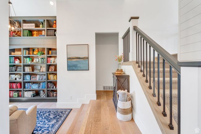 Stairs with wood finished floors and baseboards | Image 15
