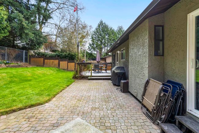 View of patio featuring grilling area, fence, and a wooden deck | Image 29