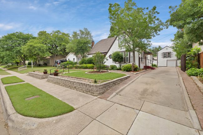 Side of home featuring driveway, a residential view, an Garage with Apartment above | Image 10
