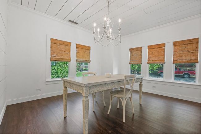 Dining space with ornamental molding, a chandelier, dark wood-type flooring, and wooden ceiling | Image 8