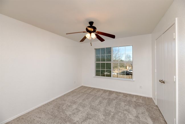 New carpeted bedroom with baseboards, carpet floors, and ceiling fan | Image 23