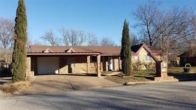 Ranch-style home with a garage | Image 1