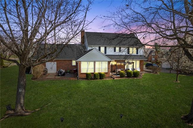 Back house at dusk featuring a patio, a pergola, and a lawn | Image 51