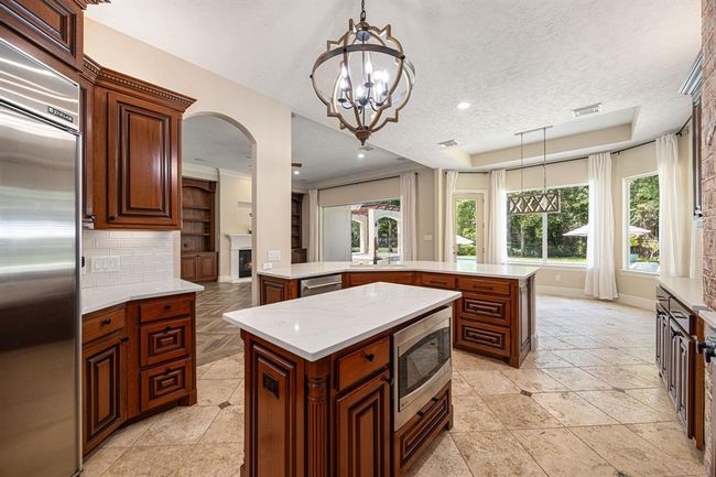 Microwave is located on the island. Jenn-Air refrigerator included with appliance package. | Image 13