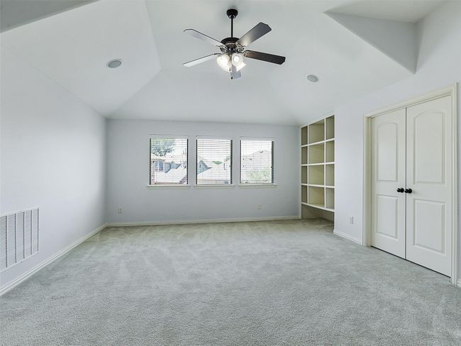 Unfurnished bedroom featuring carpet flooring, lofted ceiling, a closet, and a ceiling fan | Image 26