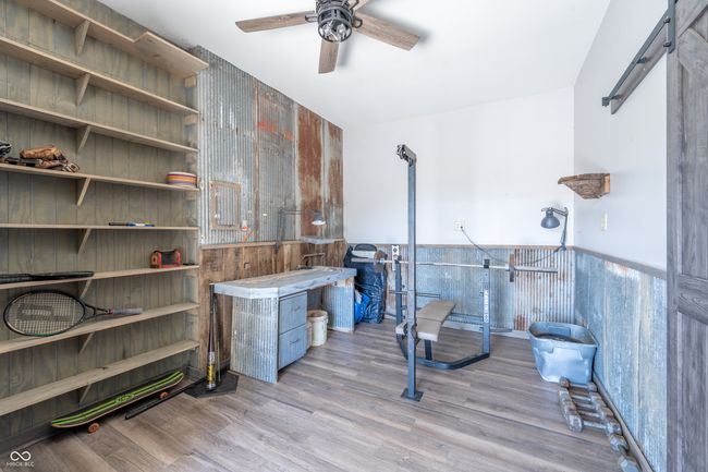 Pole barn office with wood finished floors and a ceiling fan | Image 30