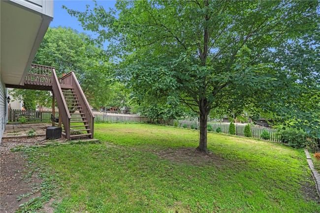 Fenced backyard with stairs and a wooden deck | Image 37