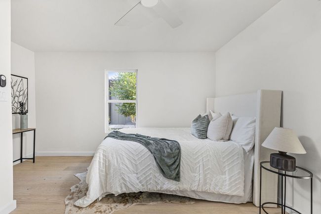 Bedroom with wood finished floors and ceiling fan | Image 25