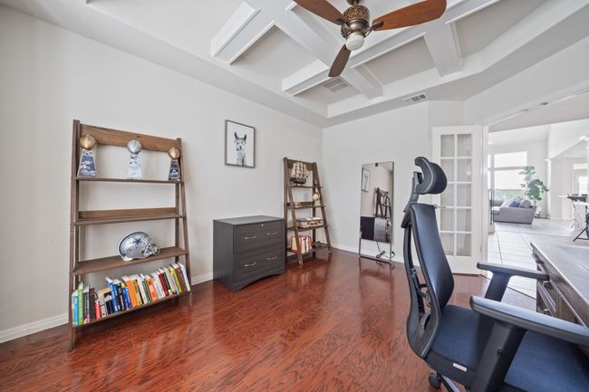 Office featuring coffered ceiling, a ceiling fan, dark wood-style floors, and beamed ceiling | Image 11