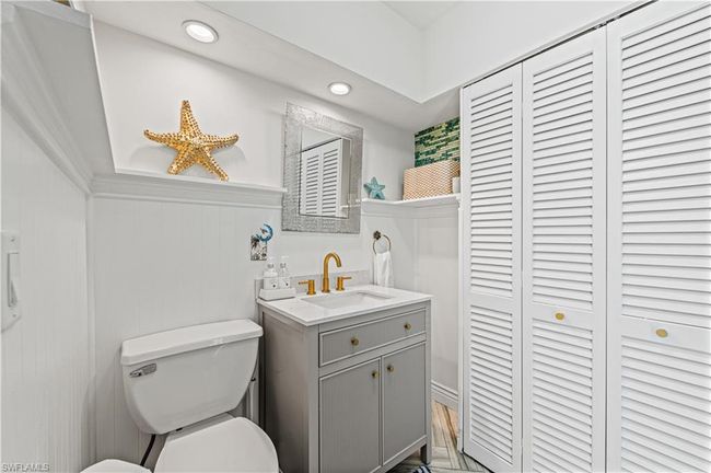 Bathroom featuring recessed lighting, toilet, vanity, and a closet | Image 21