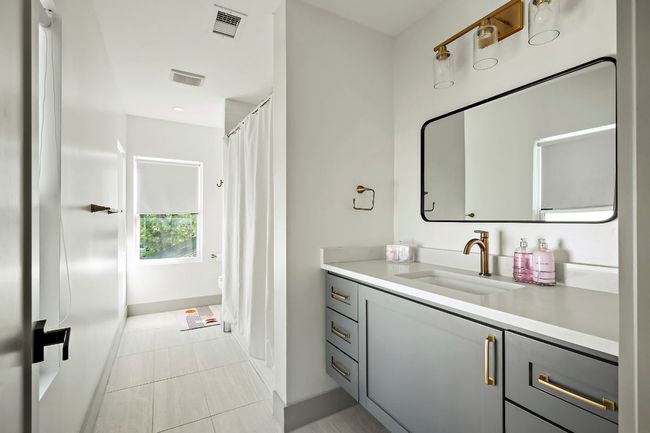 Bathroom with baseboards, visible vents, tile patterned flooring, and vanity | Image 26