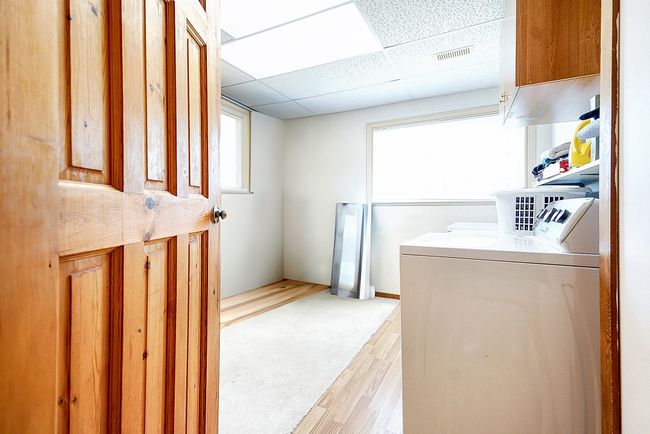 Laundry area with light wood-style floors and independent washer and dryer | Image 14