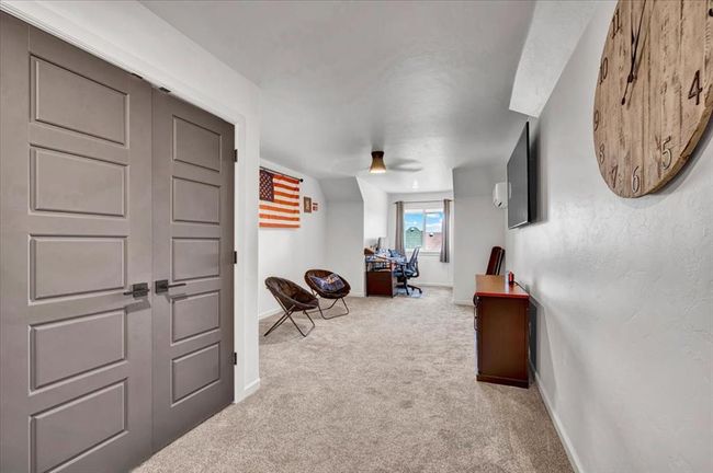 Corridor featuring carpet floors, baseboards, and an office area | Image 48