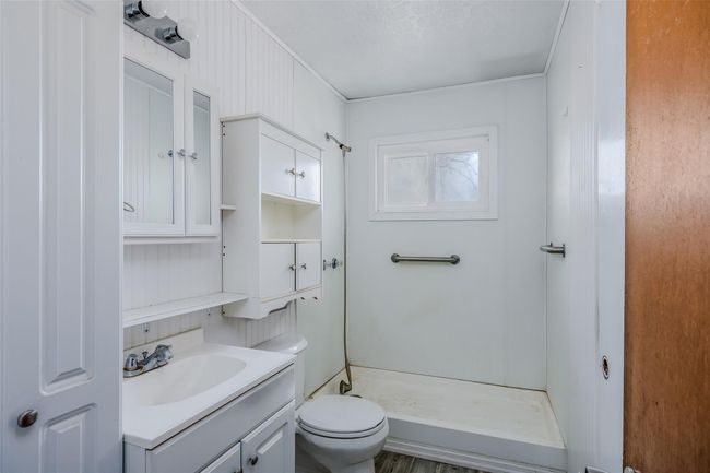 Full bathroom featuring toilet, a shower stall, and vanity | Image 17