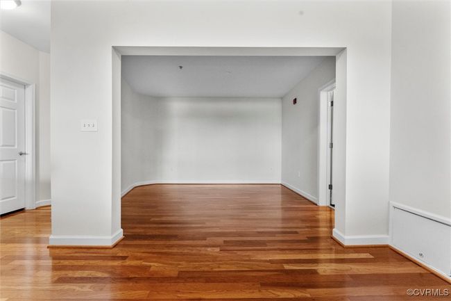 Hallway featuring radiator heating unit, baseboards, and wood finished floors | Image 30