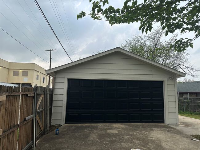 Detached garage featuring fence | Image 14