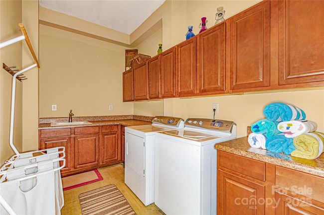 Large laundry room with cabinets and sink | Image 30