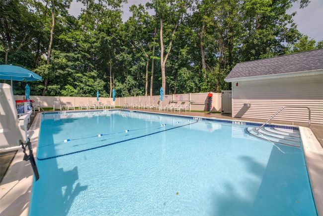 Community pool featuring view of wooded area | Image 22