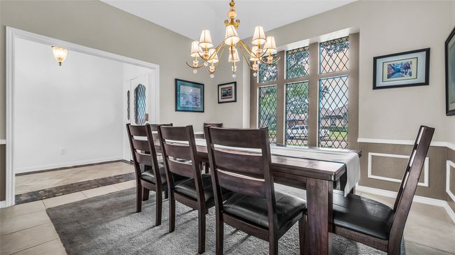 Dining space featuring a chandelier and tile patterned floors | Image 22