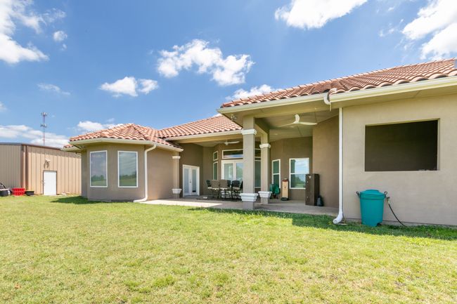 Back of property featuring stucco siding, a tiled roof, and a lawn | Image 27