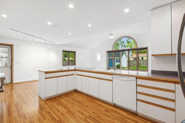 Kitchen has open flow to dinette and vaulted family room. | Image 15