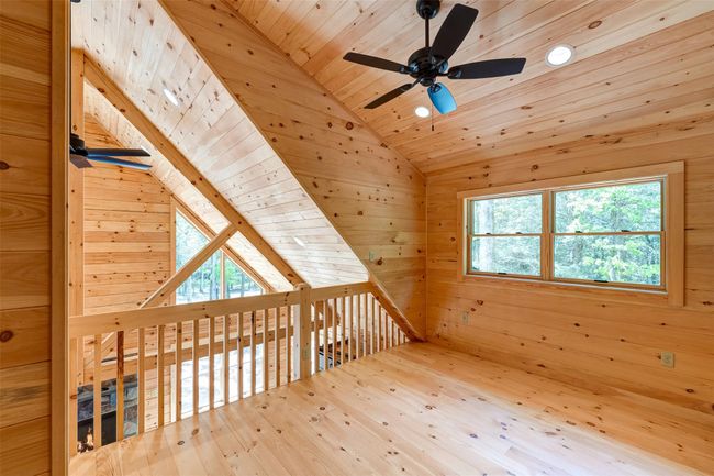 Bonus room with ceiling fan, vaulted ceiling, wood ceiling, wood-type flooring, and wood walls | Image 20