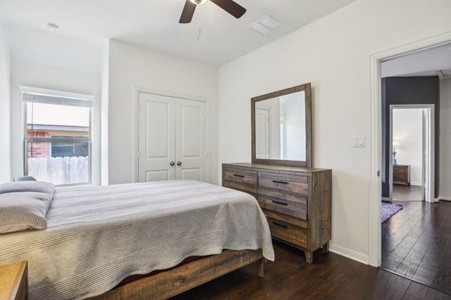 Bedroom featuring dark wood-style flooring, a closet, and ceiling fan | Image 21