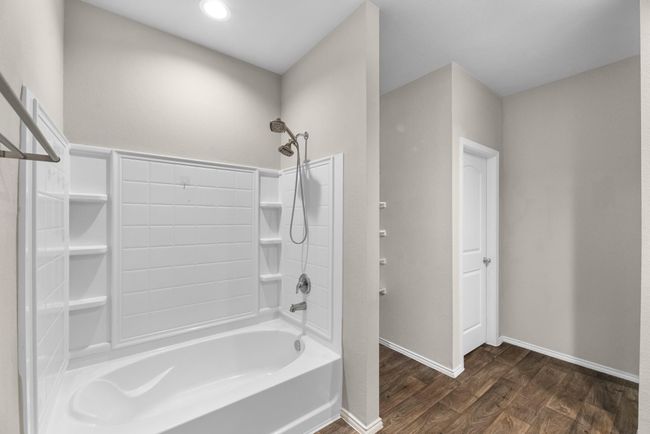 A closer view of soaking tub and convenient shelving in shower. | Image 30