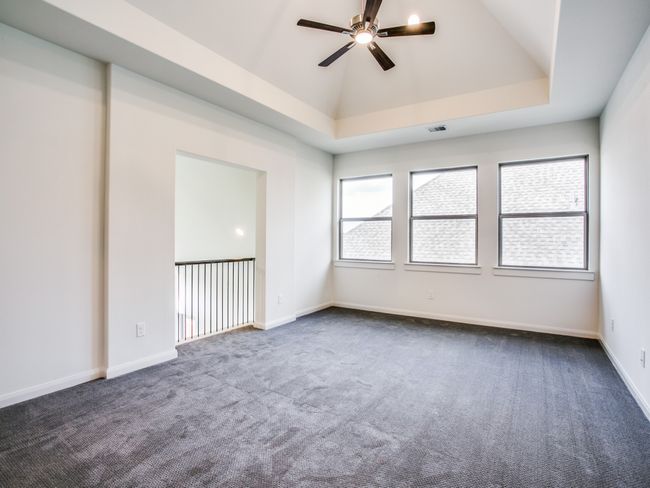 Unfurnished room with ceiling fan and dark colored carpet | Image 20