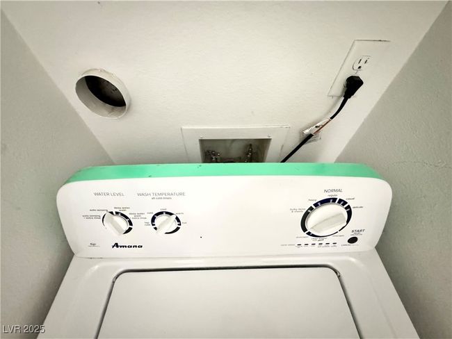 Washroom with washer / and a textured wall | Image 22