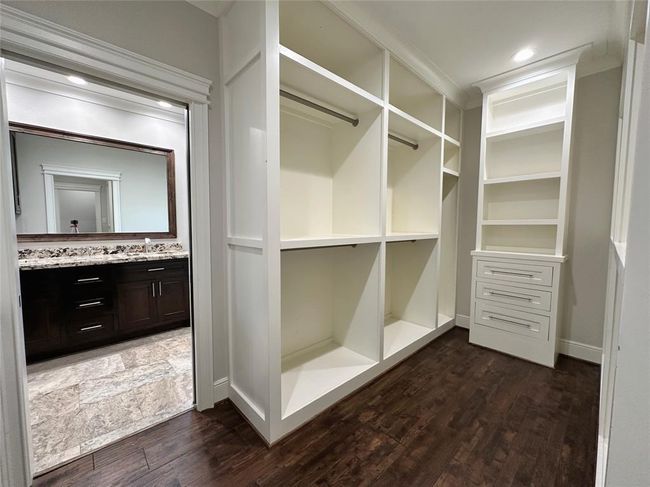 Primary closet with access to the primary bathroom and hallway to the main bedroom. | Image 18