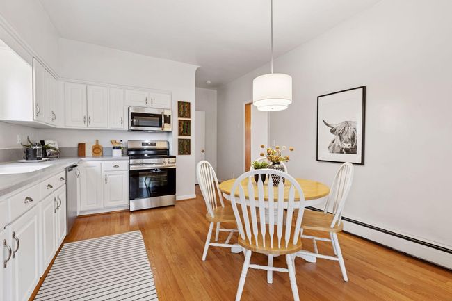 The kitchen is highlighted with lovely hardwood floors for continuity of design. | Image 15
