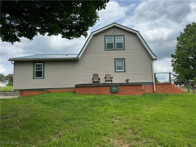 Back of house featuring a yard and metal roof | Image 5