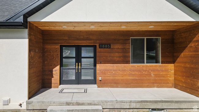 View of exterior entry with french doors and stucco siding | Image 40