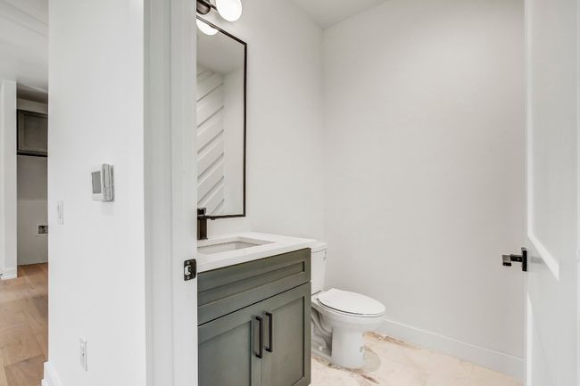 Half bathroom with toilet, vanity, and baseboards | Image 12