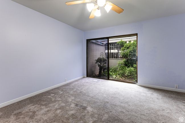 Unfurnished room with carpet, baseboards, and a ceiling fan | Image 16