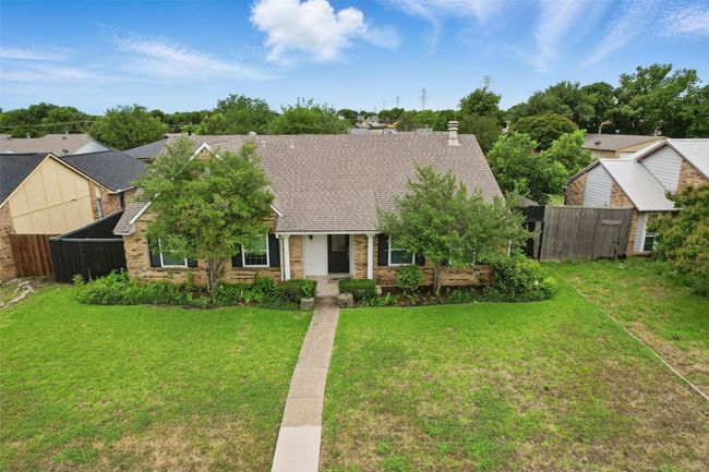 View of front of house with roof with shingles and brick siding | Image 5