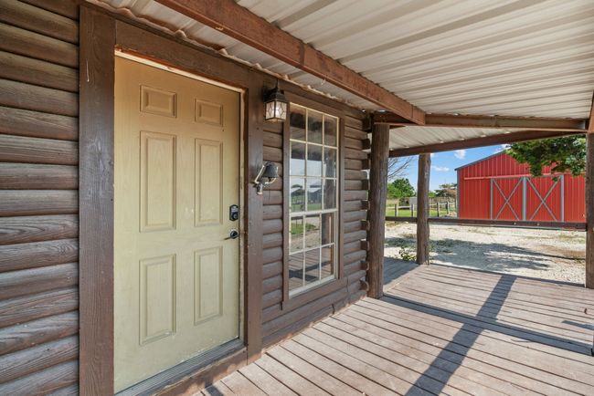 Doorway to property featuring log siding | Image 11