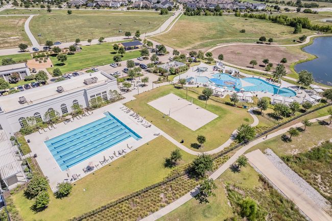 Drone / aerial view of a pool area and a nearby body of water | Image 32