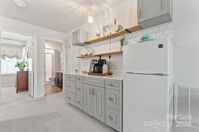 Built-in shelving and tiled wall, the perfect hang-out area. | Image 33