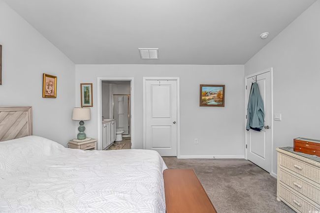 Carpeted bedroom with ensuite bathroom | Image 11