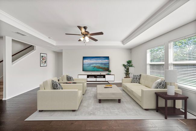 Living area with a raised ceiling, hardwood / wood-style flooring, plenty of natural light, and ornamental molding | Image 9