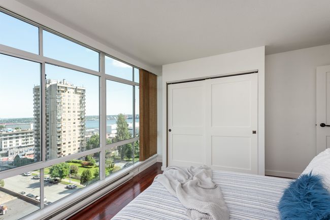 Bedroom featuring a water view, dark wood-style flooring, and a closet | Image 33